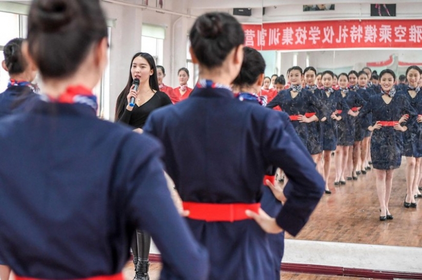 Chinese flight attendants are taught to smile, walk, stand and sit
