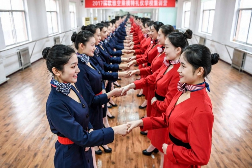 Chinese flight attendants are taught to smile, walk, stand and sit