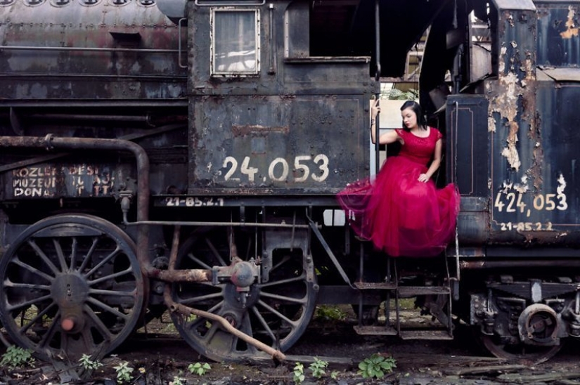 Guy photographing his girlfriend in an abandoned locations across Europe