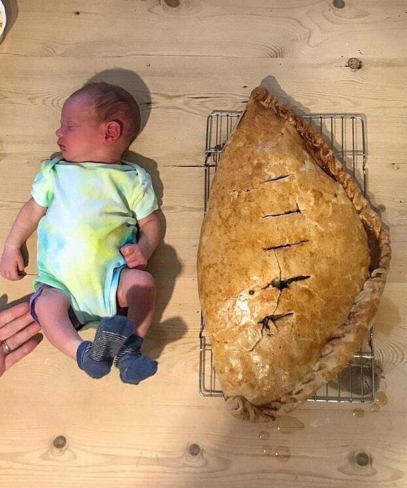 Happy father in honor of the birth of his son baked a cake the size of a child