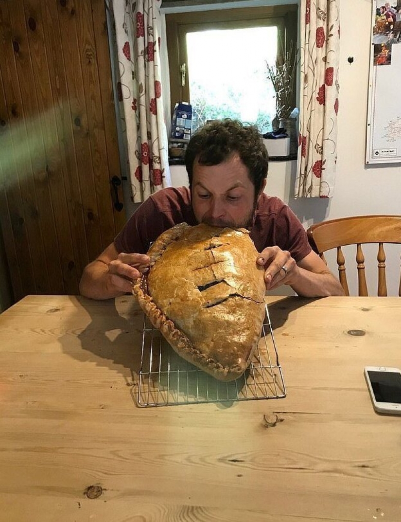 Happy father in honor of the birth of his son baked a cake the size of a child