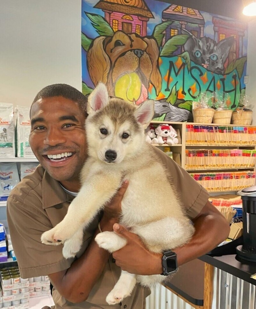 Funny courier photographed with every dog he meets