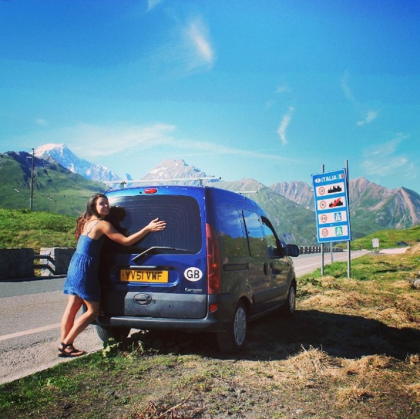 The girl has converted an old van into a motorhome and travels the world with his dog The girl has converted an old van into a motorhome and travels the world with his dog