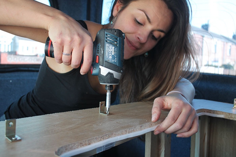 The girl has converted an old van into a motorhome and travels the world with his dog The girl has converted an old van into a motorhome and travels the world with his dog