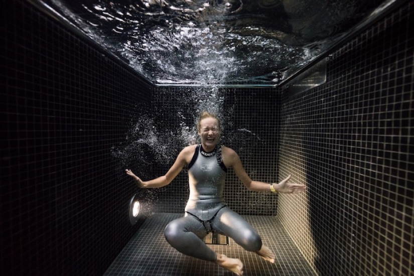 Underwater portraits of people who dived into a pool of icy water