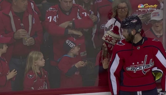 An NHL hockey player stubbornly tried to give a little girl a puck. It turned out the third time