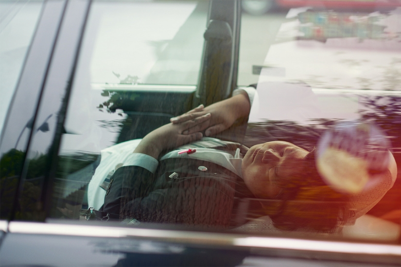 Japanese taxi drivers sleeping in the middle of the street in the middle of the day in William Green's photo series