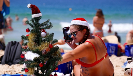 New Year and Christmas in Australian style: kangaroos instead of deer and Santa on a board with a paddle New Year and Christmas in Australian style: kangaroos instead of deer and Santa on a board with a paddle