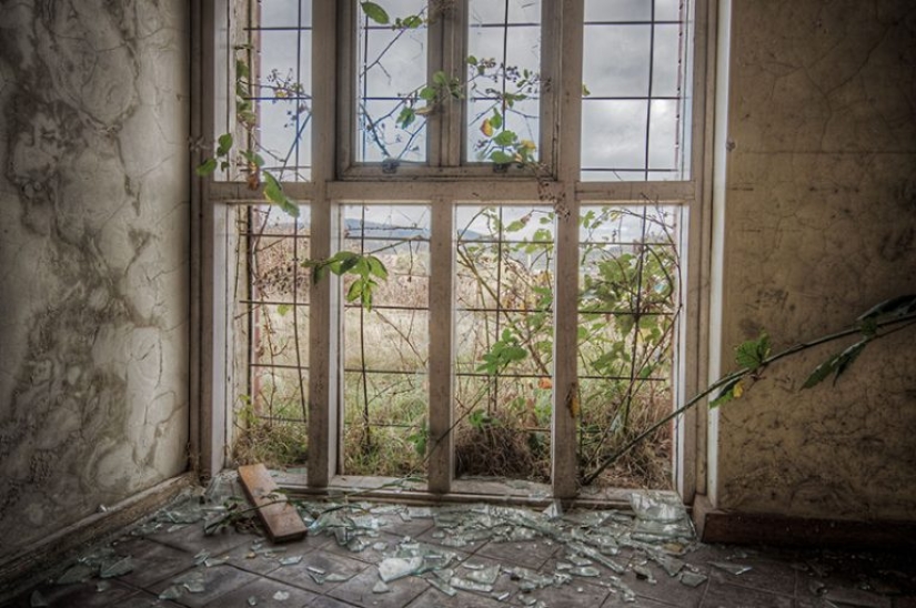 Photographer taking pictures of windows in abandoned places