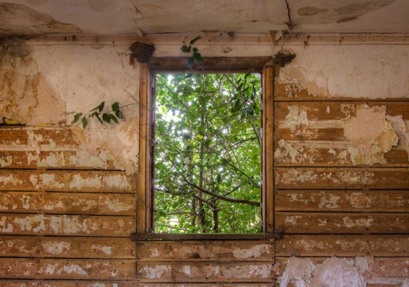 Photographer taking pictures of windows in abandoned places