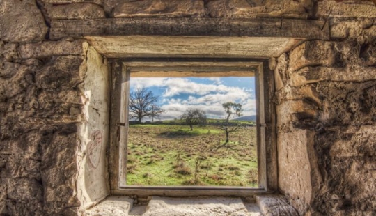 Photographer taking pictures of windows in abandoned places