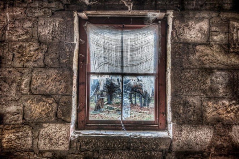 Photographer taking pictures of windows in abandoned places