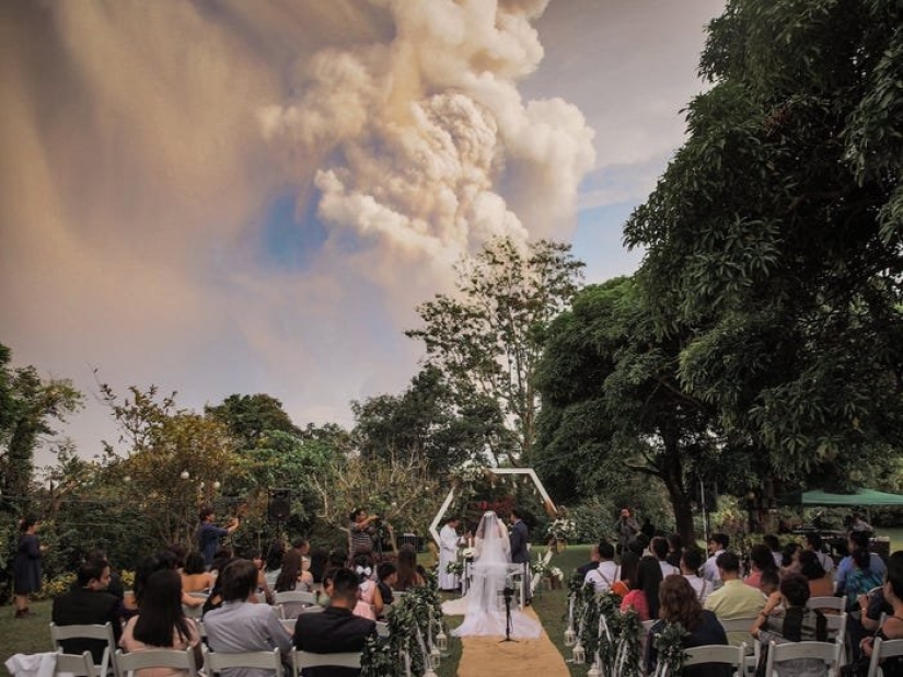 Wedding ceremony against the backdrop of an erupting volcano in the Philippines