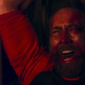 Why is a bloody Nicolas Cage running through the woods with a chainsaw