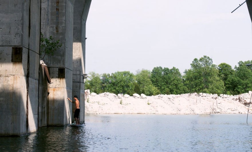Women coming out of the water — the creation of an artist balancing on a surfboard