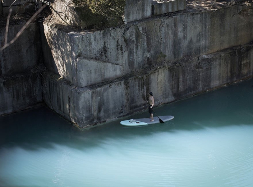 Women coming out of the water — the creation of an artist balancing on a surfboard