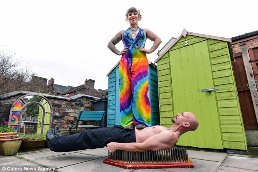 A British woman dropped out of university for a circus performance where she drives nails into her father's nose