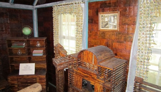 A house where everything is from newspapers: walls, furniture, and even curtains