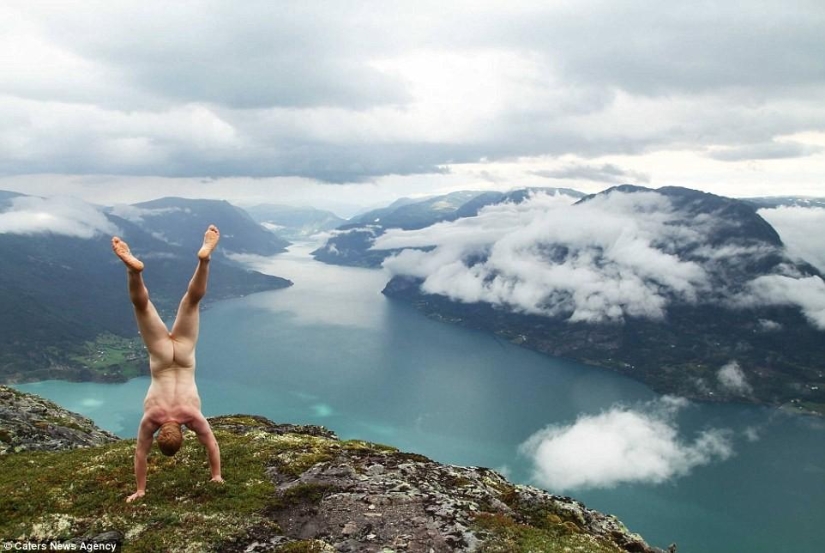 An exhibitionist traveler takes a naked photo against the backdrop of nature and city attractions
