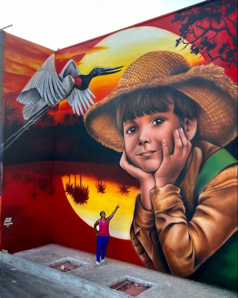 Artista callejero continúa pintando retratos en paredes junto a árboles que también sirven como cabello