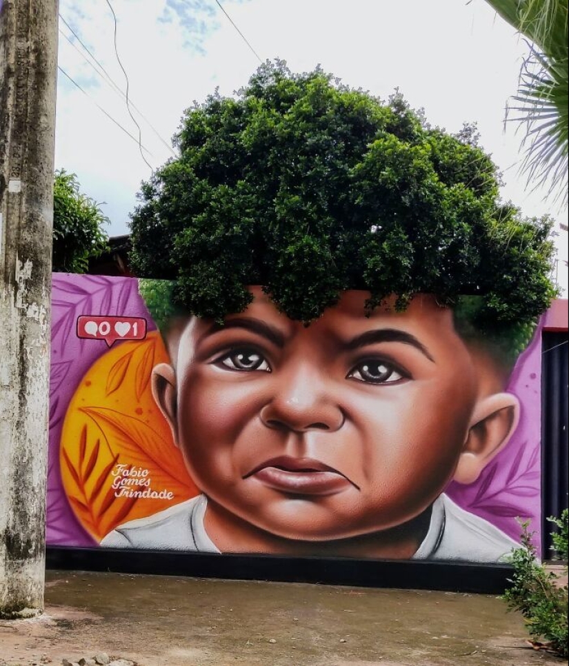 Artista callejero continúa pintando retratos en paredes junto a árboles que también sirven como cabello