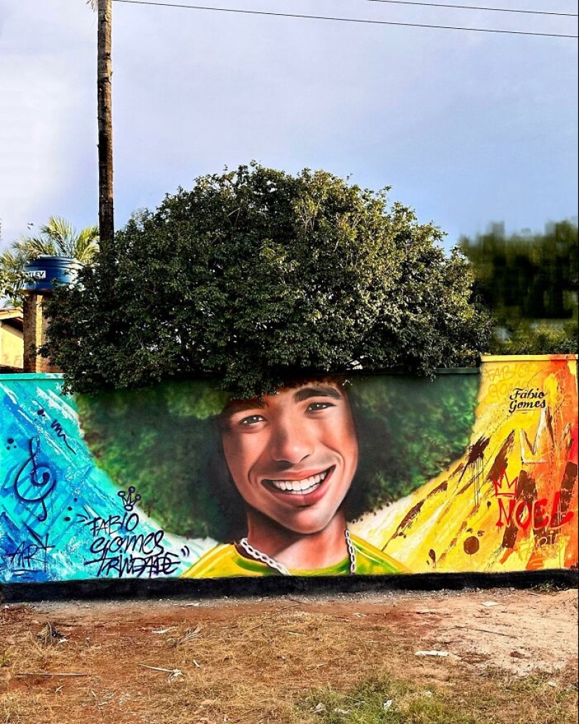 Artista callejero continúa pintando retratos en paredes junto a árboles que también sirven como cabello