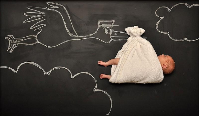 Mom takes a picture of the baby on the "Adventure Board" Mom takes a picture of the baby on the "Adventure Board"