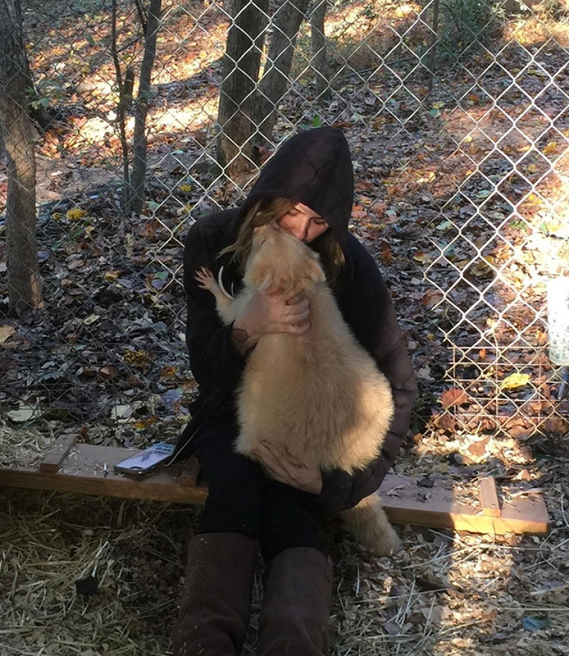 The "aggressive" albino raccoon just can't stop hugging her savior