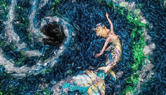 Why did the photographer drown the mermaids in plastic bottles
