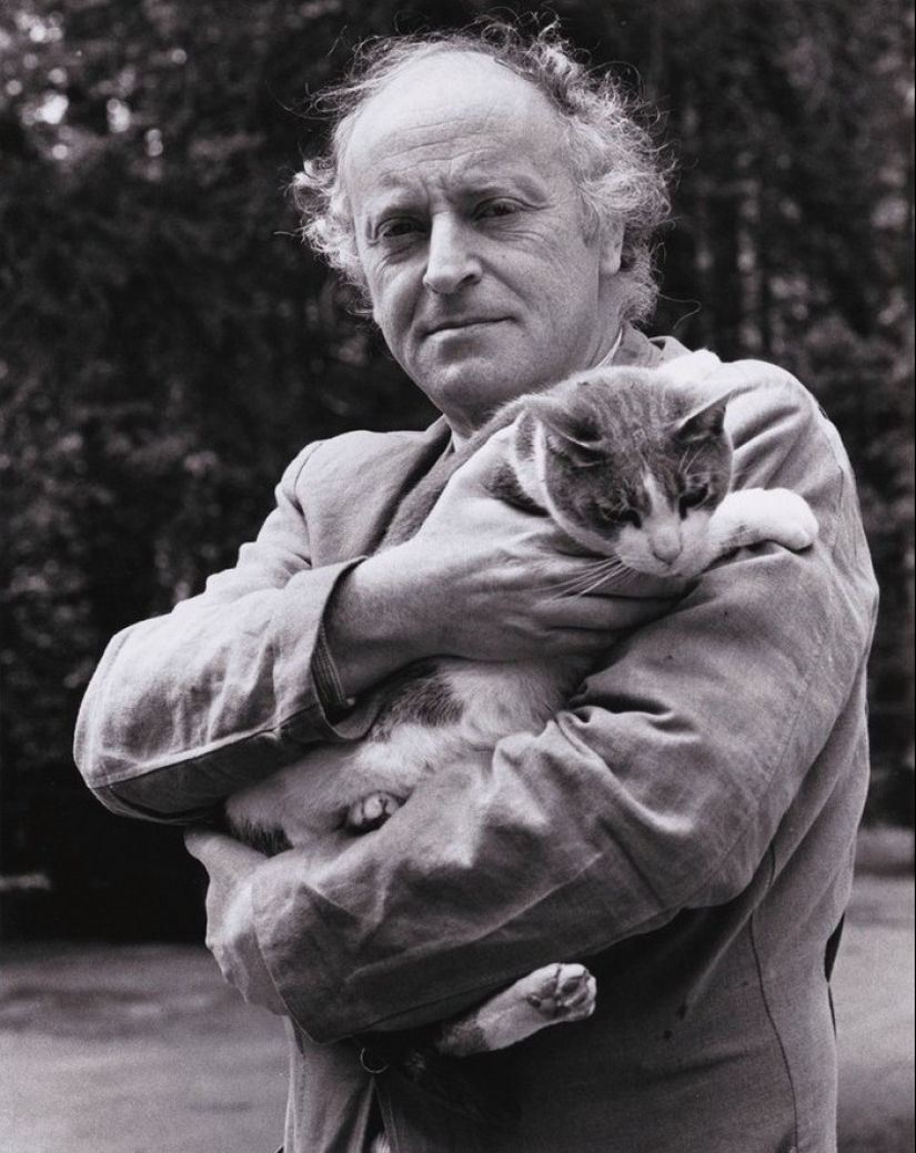 Behind every great man there is a cat