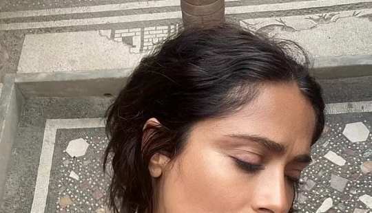 Salma Hayek, 57, is a makeup-free beauty as she eats a strawberry fresh off the vine during trip to 'magical' island in Italy