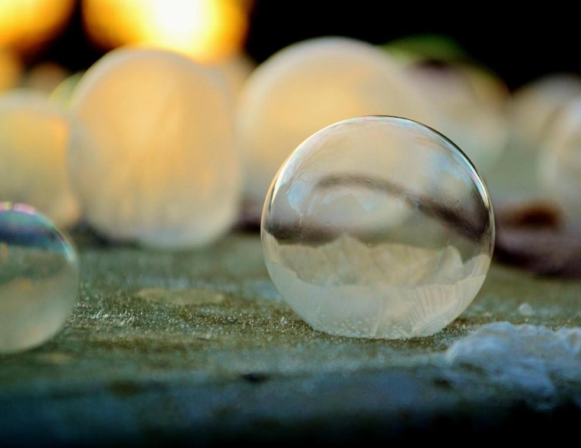 Crystal balls — a girl photographs soap bubbles in the cold