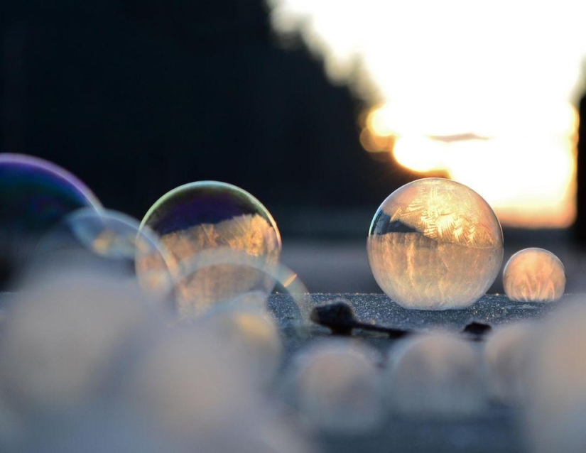 Crystal balls — a girl photographs soap bubbles in the cold