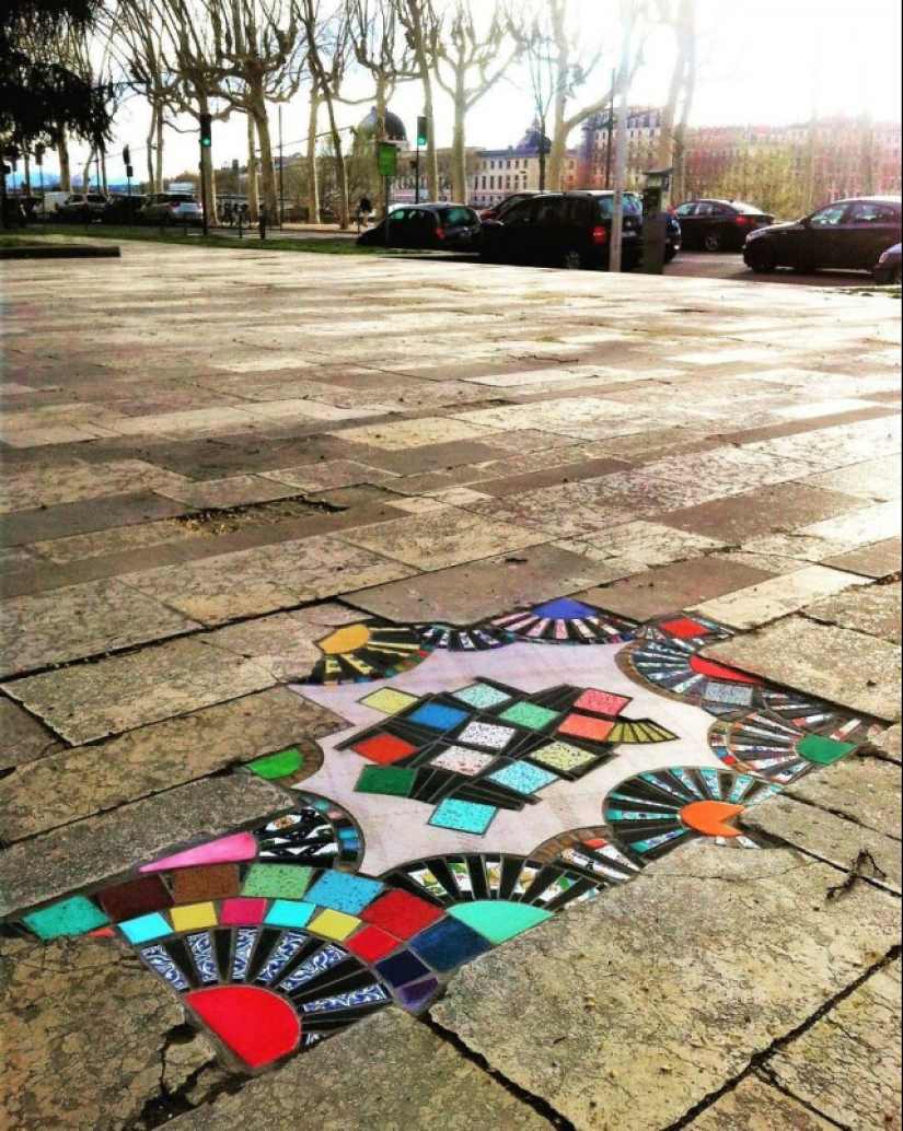 Road surgeon from Lyon: Street artist patches potholes with mosaics Road surgeon from Lyon: Street artist patches potholes with mosaics