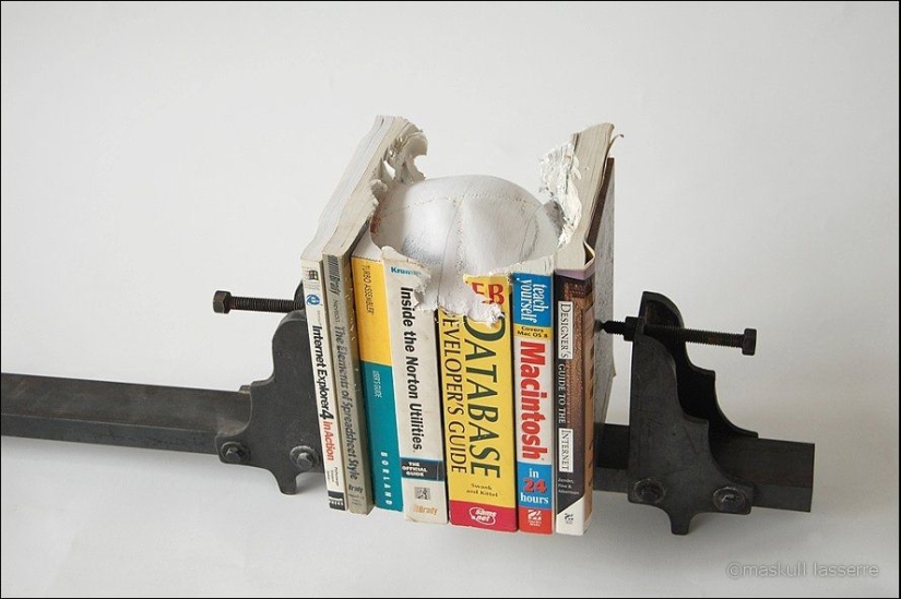 Step-by-step process of carving a skull from old books