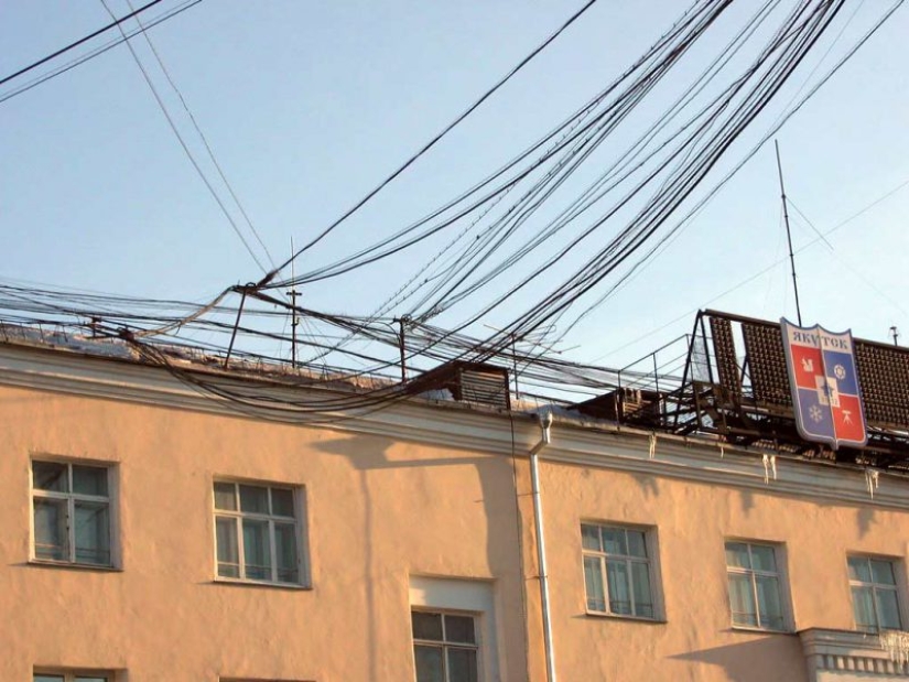 Who and why stretches wires between houses Who and why stretches wires between houses