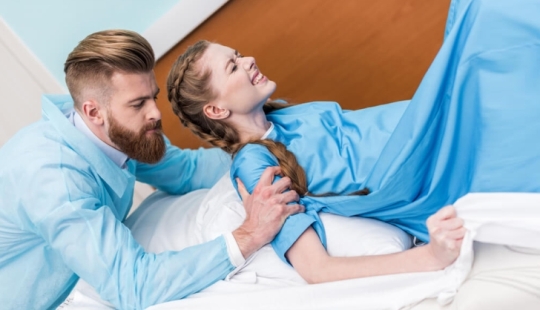 Why do women give birth lying down and what does King Louis XIV have to do with it